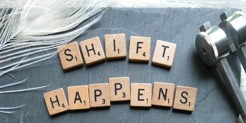 older woman's hand holding younger person's hand in support 